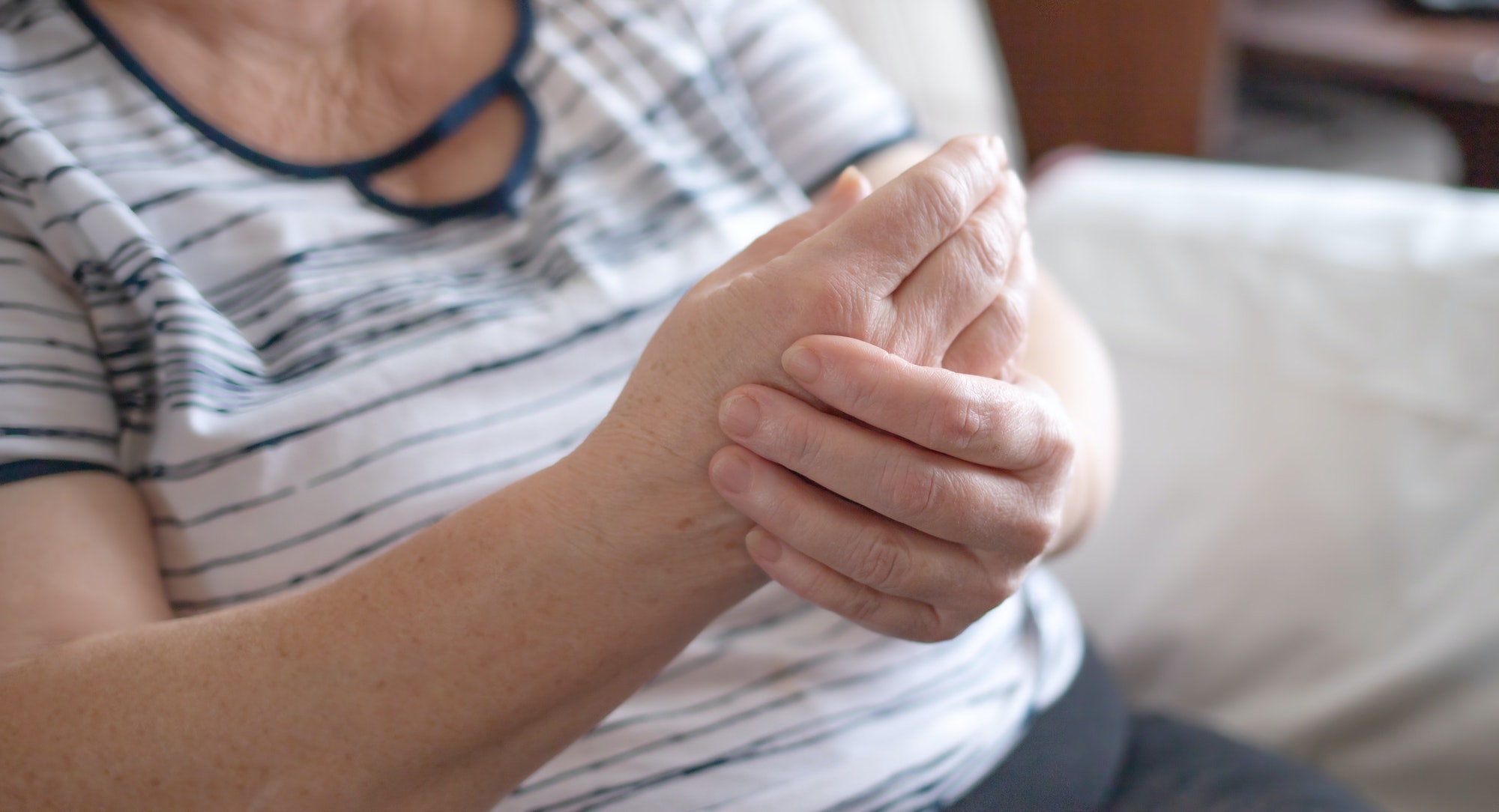 An elderly woman suffers from joint pain. the concept of medicine, the treatment of the disease